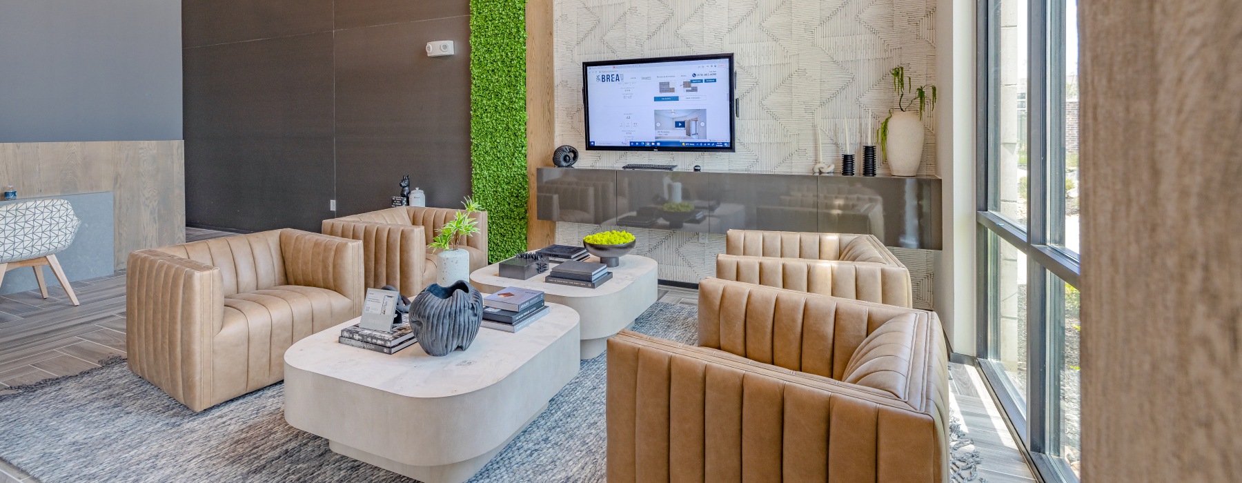 Stylish resident lounge at Brea Frisco with modern seating, natural light, and inviting community space