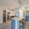 Spacious and well lit kitchen with wood flooring and stainless steel appliances