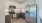 Spacious and well lit kitchen with wood flooring and stainless steel appliances