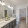 Large well lit bathroom with white accents 