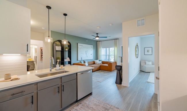 Kitchen Spacious and well lit kitchen with wood floors and stainless steel appliances